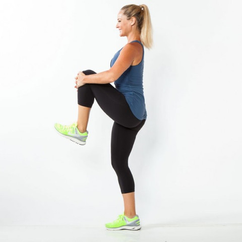 Standing knee hugs are a great exercise to improve your golf game